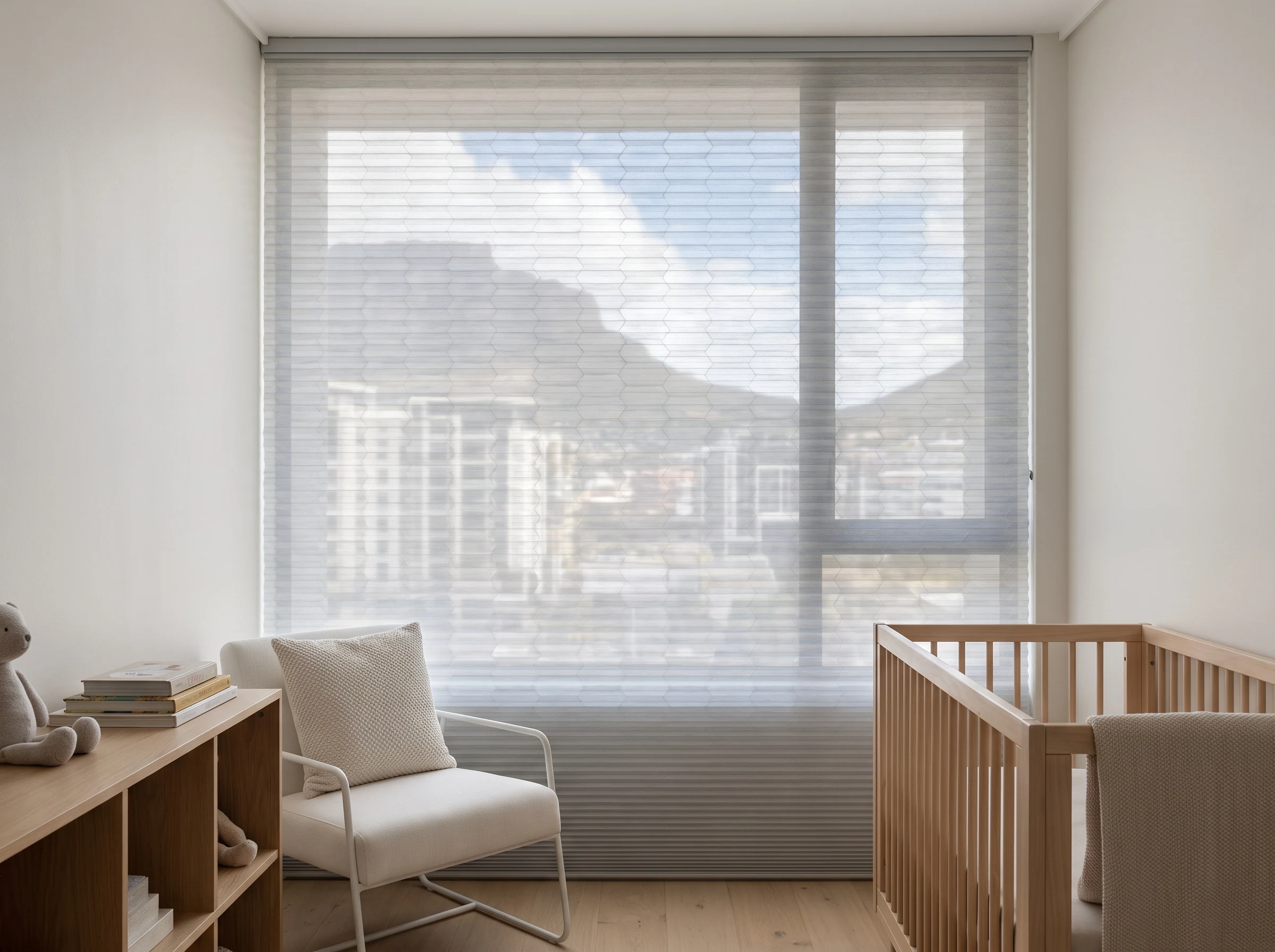 Cellular honeycomb blind with visible hexagonal cells lowered over a nursery window in a Century City apartment